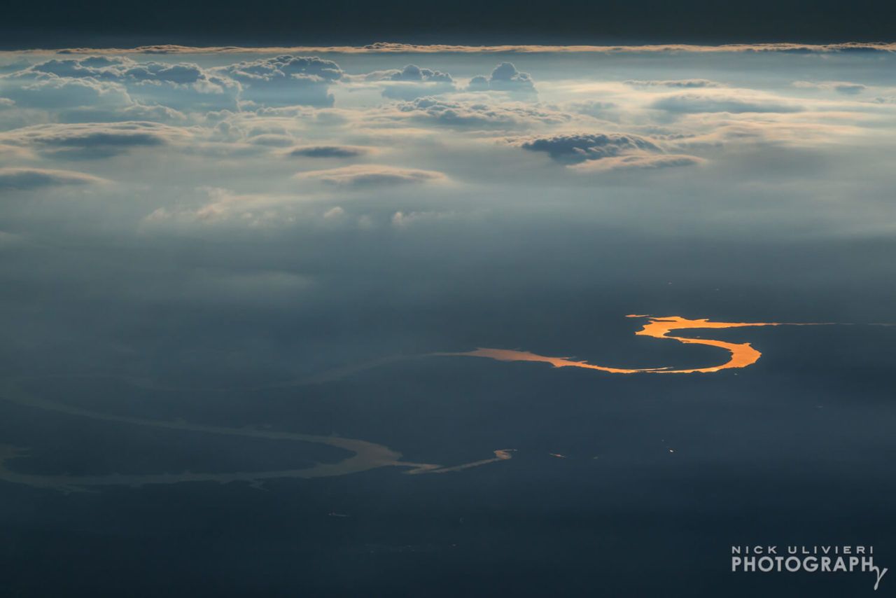 Sunlight glints off a distant river