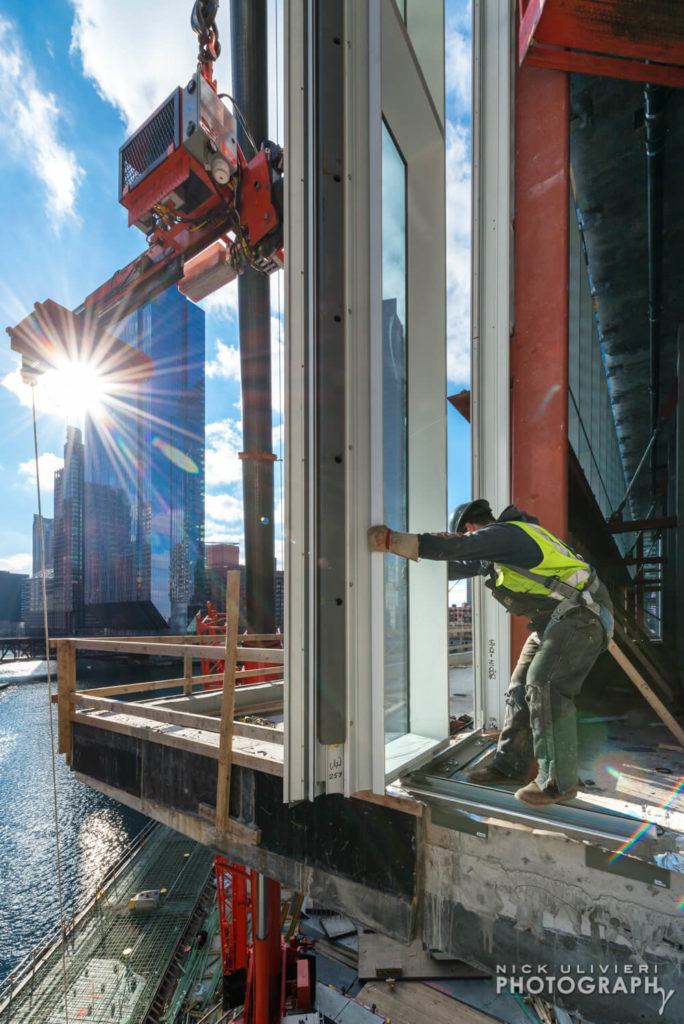 Hanging glass at Wolf Point East  for Walsh Group