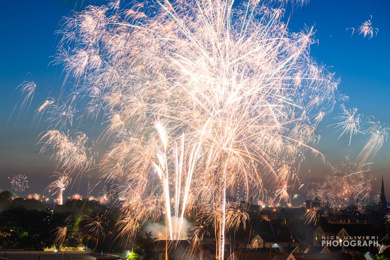 Crackling sparks fill the frame as a nearby firework explodes.