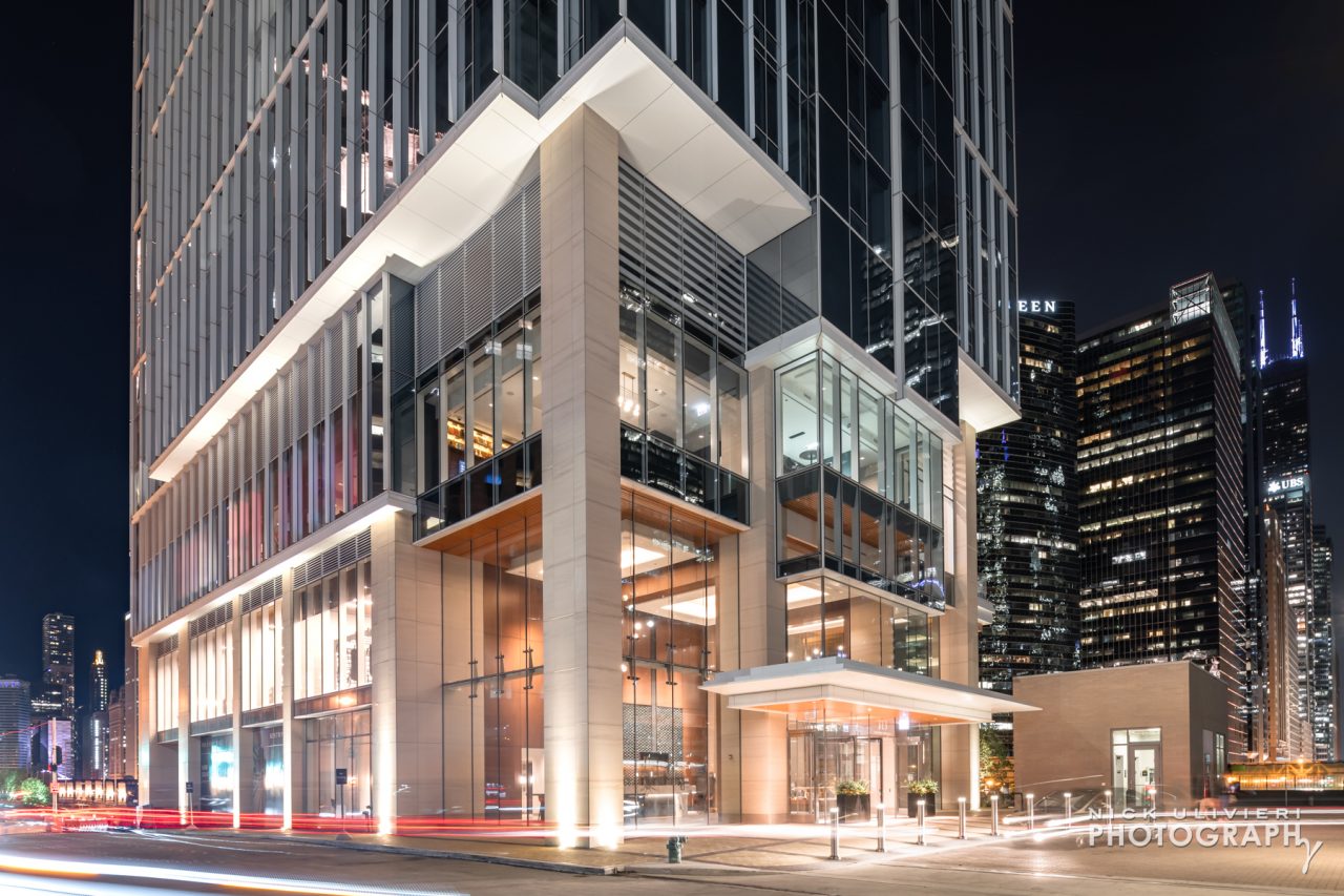 A nighttime view of Wolf Point Easts entrance and podium
