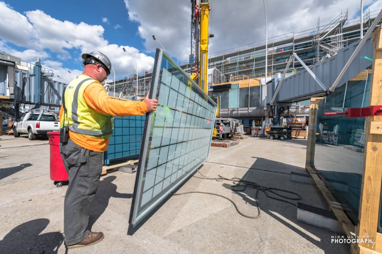 A pane of glass is about to be sent up for installation on the roof