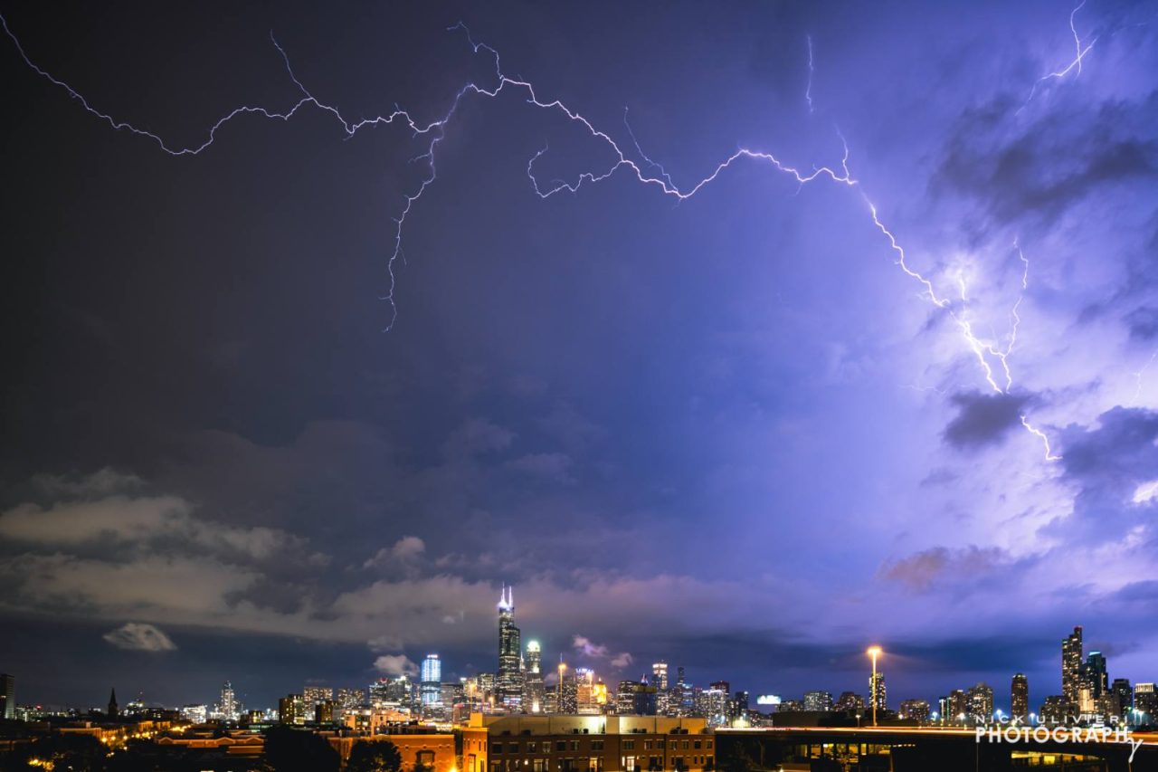 Lightning out over the lake arcs across the sky