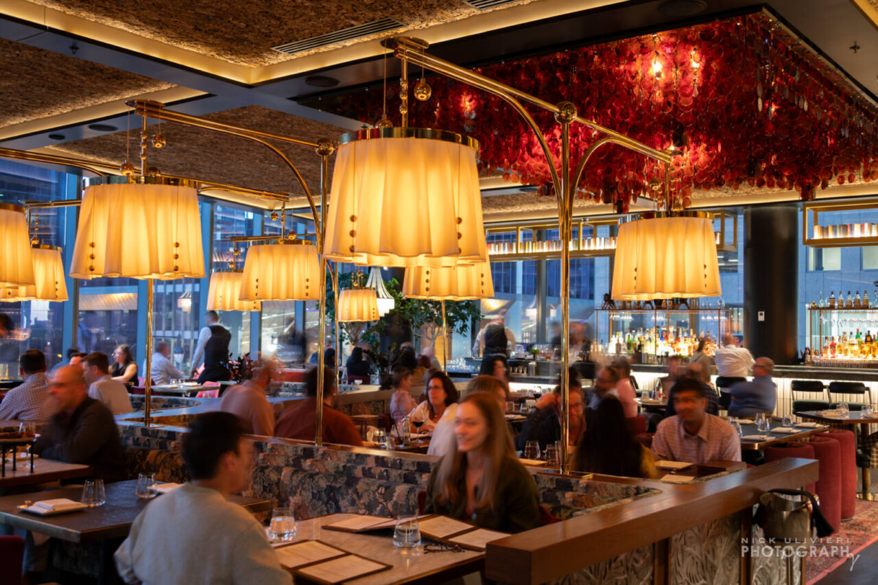Bazaar Meat's main dining room feature a warm, luxe space