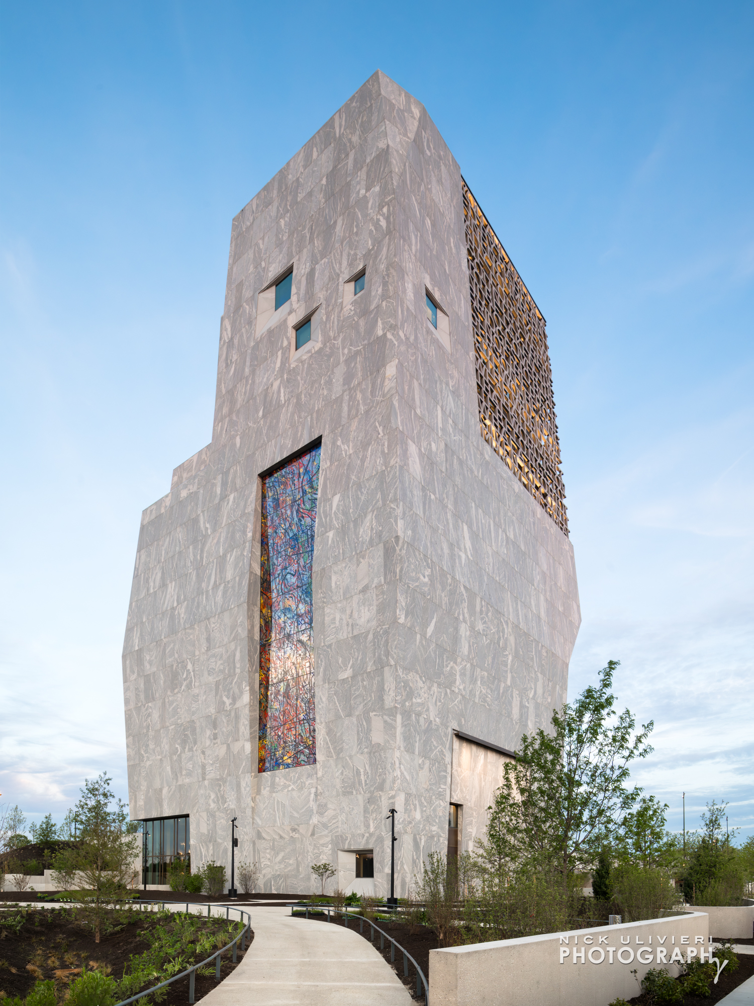 A full-height image of the Museum tower focused on the North facade. Julie Mehretu's massive stained glass window wall is featured.